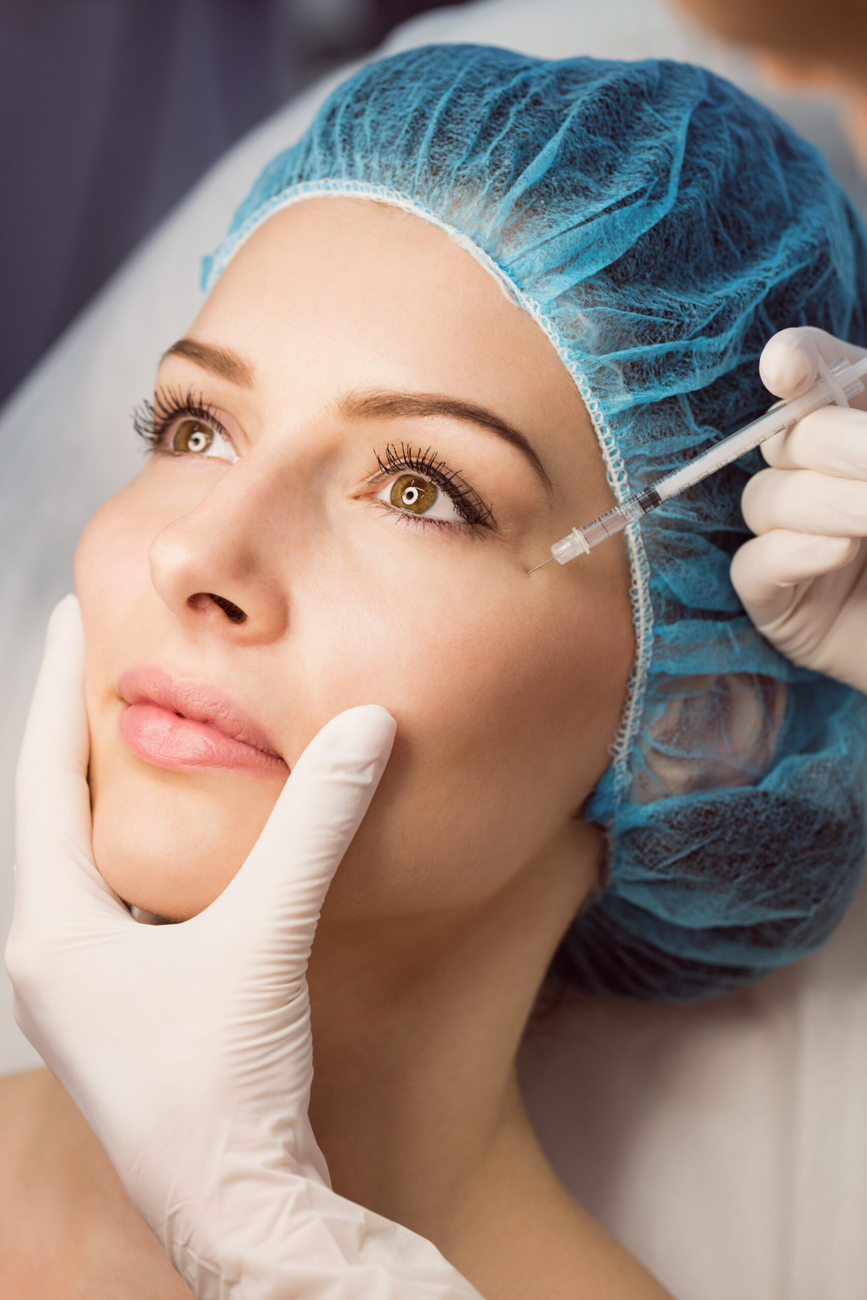 Close-up of female patient receiving an injection on her face in clinic